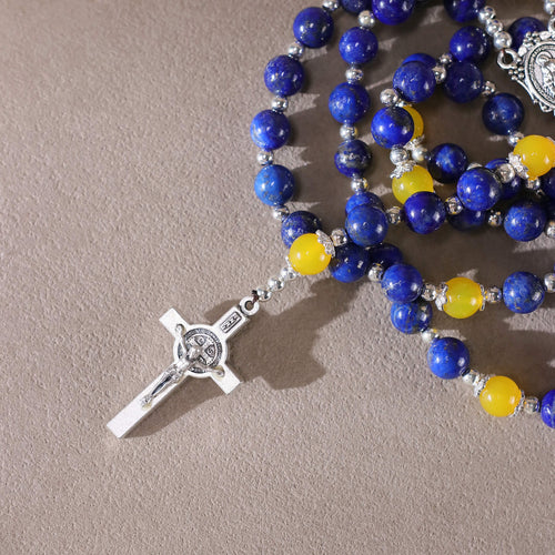 Close-up of natural lapis lazuli and yellow agate beads on catholic rosary