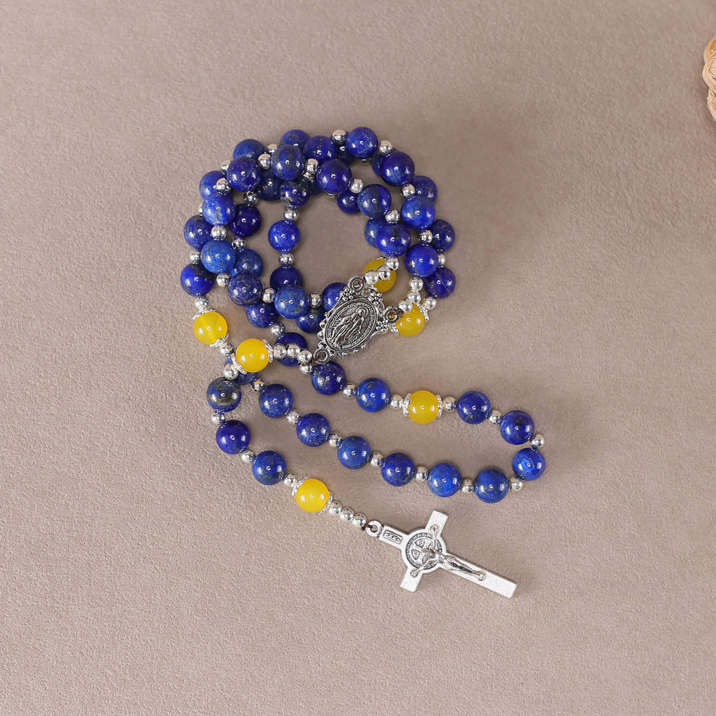 Coiled handmade catholic rosary with 8mm natural lapis lazuli beads and yellow agate accents, holy medal and saint benedict crucifix
